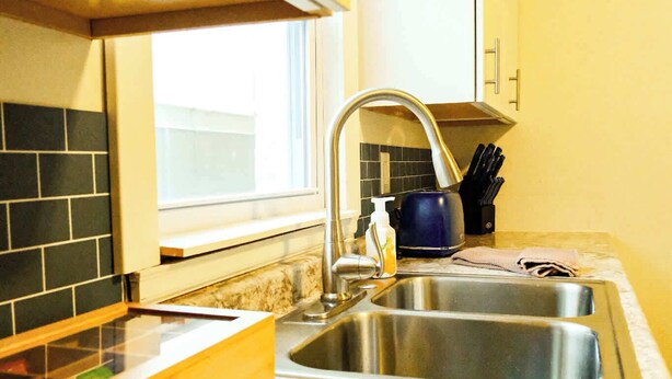 A kitchen with a sink, a window, and a countertop. - Aurora Loft | 2BR | ORV Trail 2 + Iron Belle (Ironwood)