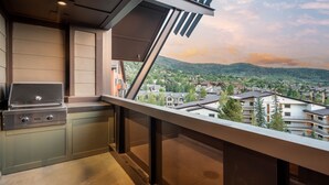 A balcony with a built-in grill and a view of a residential area. - Steamboat Square Views | One Steamboat Place 512 (Steamboat Springs)