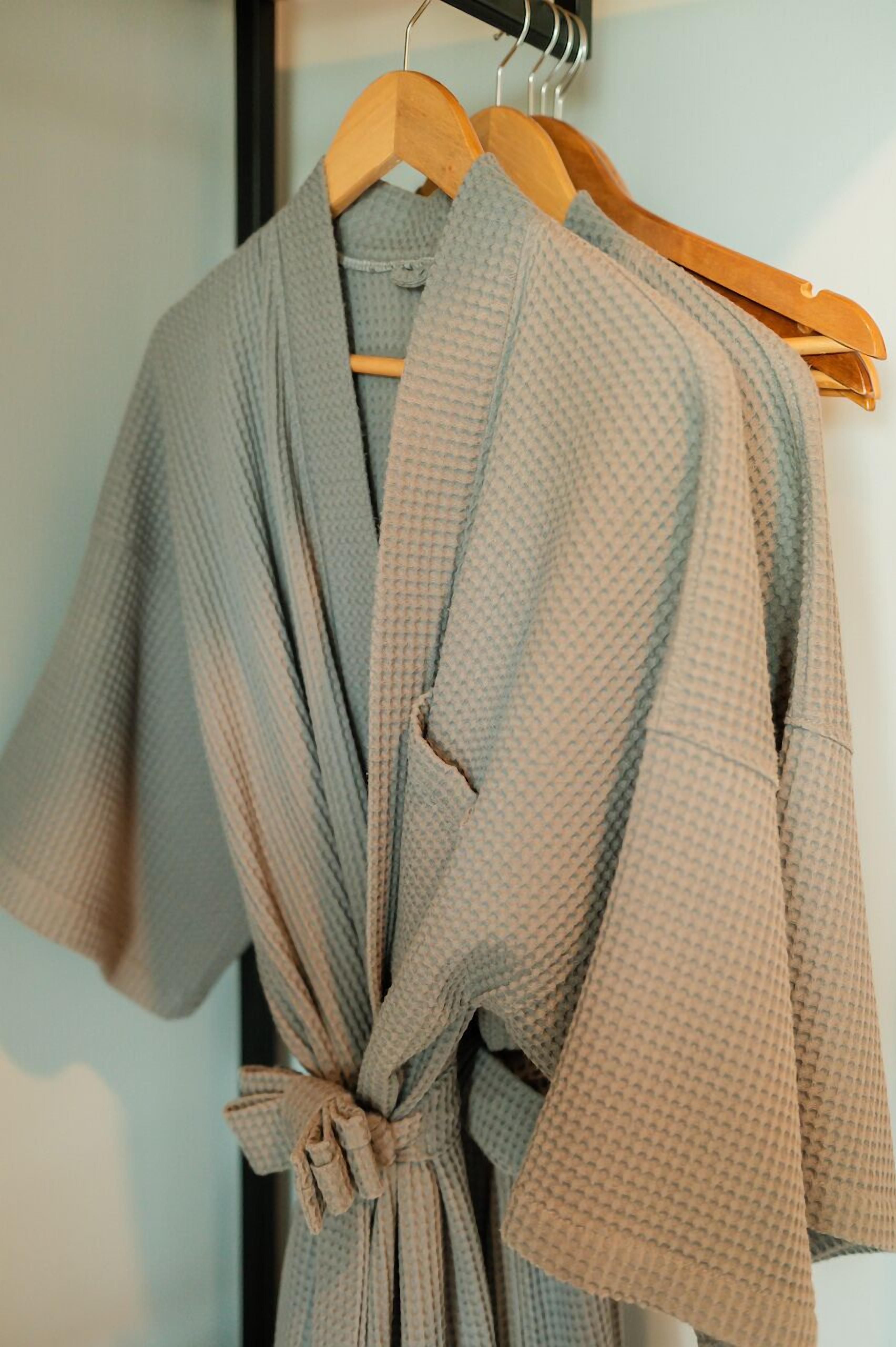 A robe hanging on a wooden hanger.