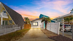A residential street with houses, a clear sky, and a sunset. - 5 Min Walk to Sand | King Bed | Private Yard! (Panama City Beach)