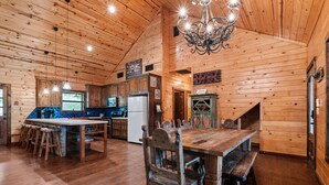 A rustic wooden interior with a large dining table, bar area, and kitchen. - Right in the heart of Concan, private swimming pool, epic views & a 2-minute drive to THE Frio River (Concan)