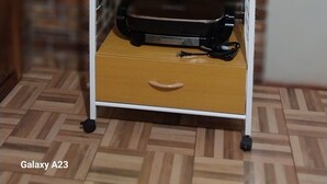 A kitchen with a white microwave, a black slow cooker, and a coffee maker on a wooden shelf. - Apartamentos Amueblado (Corredores)