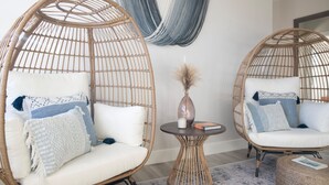 Two wicker chairs with white cushions and blue accents, a woven table, and a blue and white hammock. - Luxury Home - Jacuzzi! Mini-Golf! Ping-Pong! Pets! 2 Desks! Yoga! Beach Gear! (North Palm Beach)