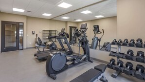 A gym with treadmills, elliptical machines, and a rack of dumbbells. - MainStay Suites North - Central York (York)