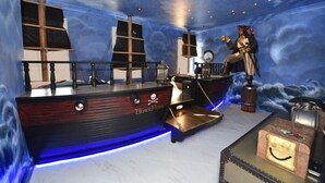 A room with a nautical theme, including a ship-shaped bar and a statue of a pirate. - Charming 3Bd Pool TH The Enclaves at Festival-350CD-NEW (Davenport)