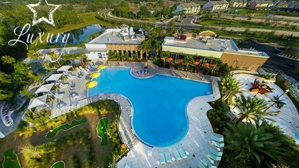 A luxury resort with a large swimming pool, sun loungers, and a golf course. - Charming 3Bd Pool TH The Enclaves at Festival-350CD-NEW (Davenport)