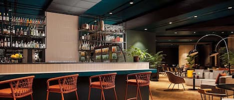 A bar area with a counter, multiple shelves of bottles, and wicker bar stools.