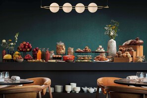 Um buffet de café da manhã com diversos alimentos e uma seleção de bebidas.