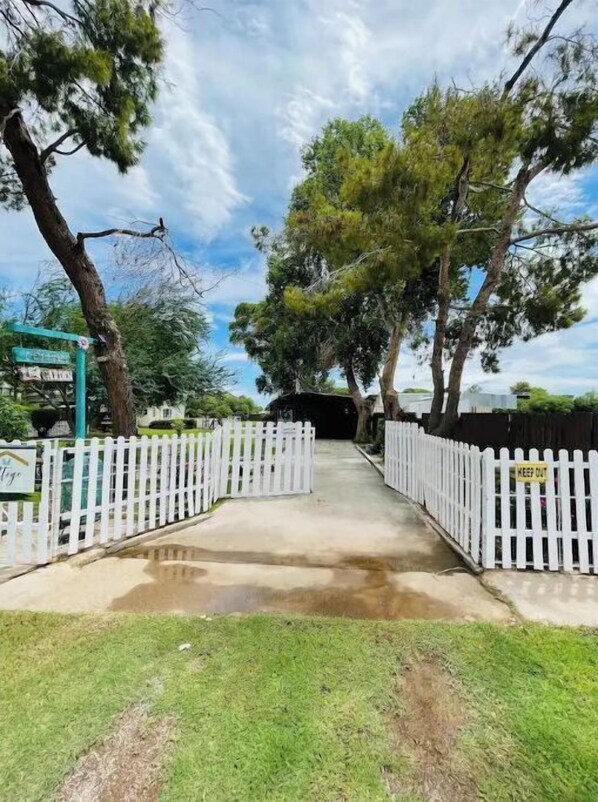 Enter a serene natural setting surrounded by trees, with an entrance and clear directions to various areas.