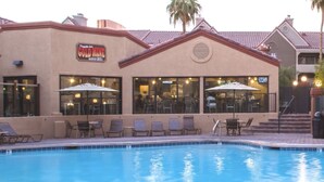 A poolside area with lounge chairs and umbrellas, a bar and grill named "Cold Mine," and a building with a beige facade and red-tiled roof. - In The Center Of It All, Right Next To The Sphere, Ten Minute Walk To The Strip (Las Vegas)
