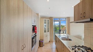 Enjoy a scenic view from the kitchen window, featuring an oven and gas stove.