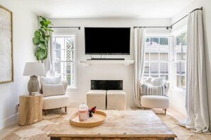 Relax in style with a comfortable sofa, large TV, and fireplace.