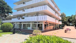 A multi-story hotel with a modern design, featuring balconies on each floor and a ground-level restaurant. - Holiday apartment Spacious, close to the sea, with air conditioning (Bibione)