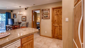 A kitchen with wooden cabinets, a granite countertop, and a built-in oven.