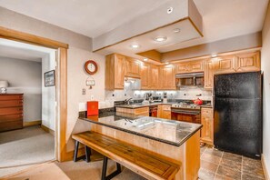 Enjoy cooking in this well-equipped kitchen with a central island and ample counter space.