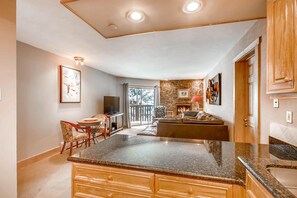 Enjoy cooking in this well-lit kitchen with a central island and large window offering a view of the outdoors.