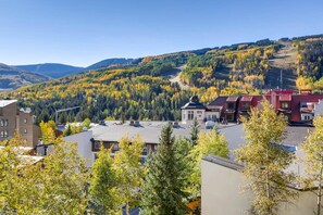A town with buildings and a forested hillside. - Westwind 404 3BD 3BA Platinum Condo in Lionshead Village (Vail)