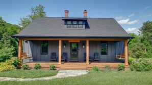 A two-story house with a covered porch, a chimney, and a number '2088' on the front pillar.
