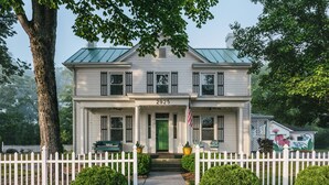 A two-story house with a green door, white picket fence, and a number 2925 on the front. - Willow Suite ~ 1 of 5 Unique Stays at Basswood ~ Ground Floor with Ramp Access (Capon Bridge)