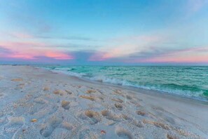 A beach with a clear sky and calm sea. - Beautiful 3bed 2 bath home with gated backyard minutes from the beach and shops (Navarre)