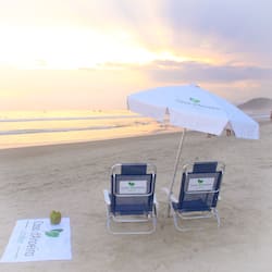 On the beach, white sand, sun-loungers, beach umbrellas