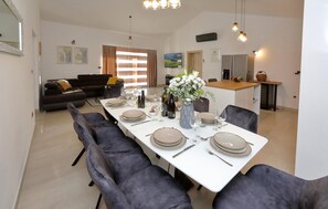 Enjoy meals in this stylish dining area with a long table and comfortable seating for six.