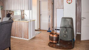 A rustic kitchen with wooden walls, a sink, and a stove. - 3 bedroom awesome home in Vikersund (Vikersund)