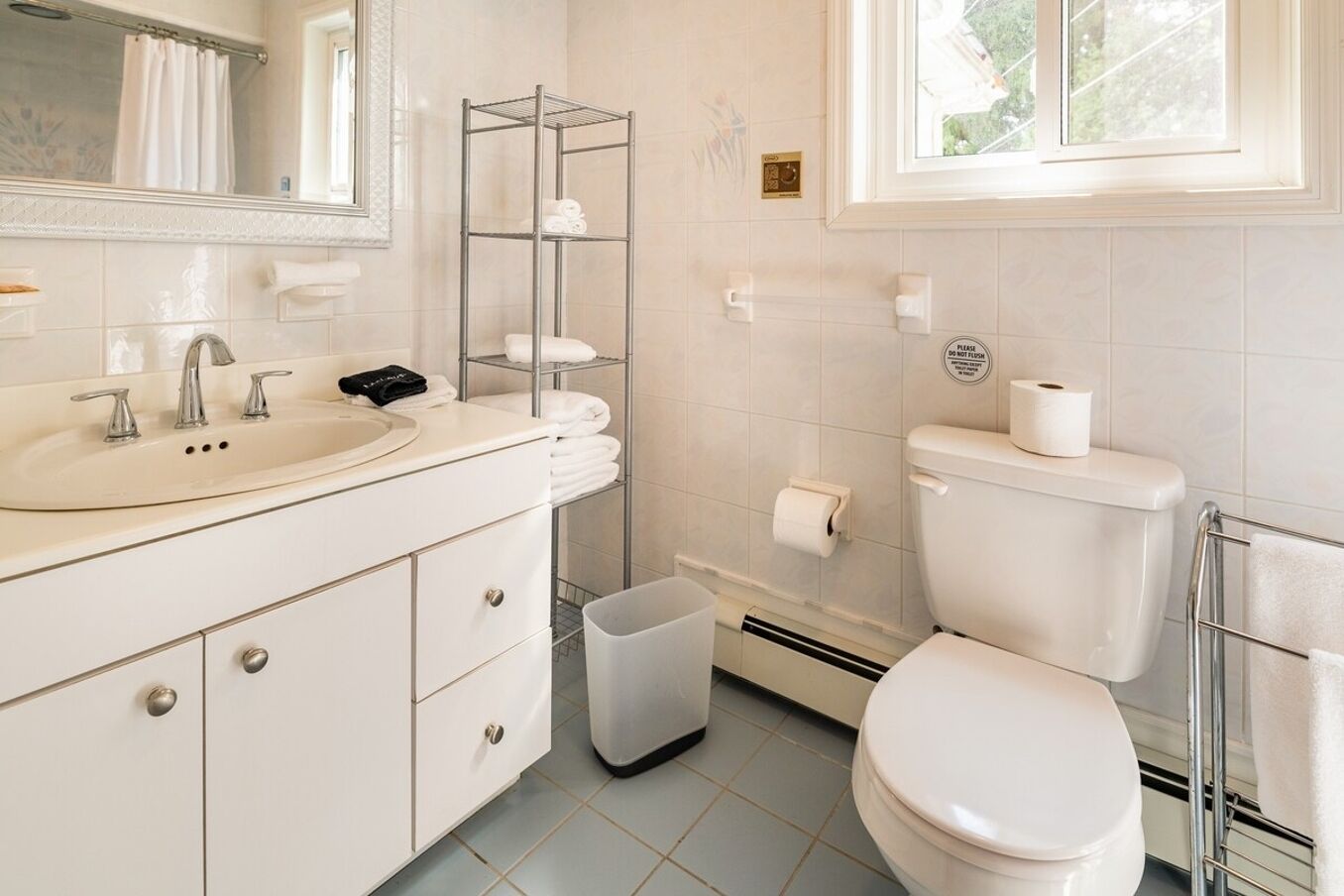 A bathroom with a sink, toilet, and shower area.
