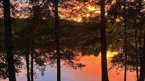 A campsite with a kayak, a chair, and a tent. - Visit your kids at uconn and get away (Mansfield)