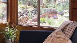 Ein gemütliches Zimmer mit einem großen Fenster mit Blick auf einen Garten.
