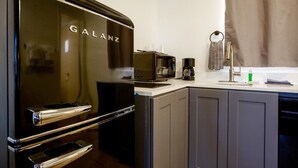 A modern kitchen with a Galanz refrigerator, a coffee machine, and a sink. - Kitchenette Room in Sedona at Thunder Mountain (Sedona)