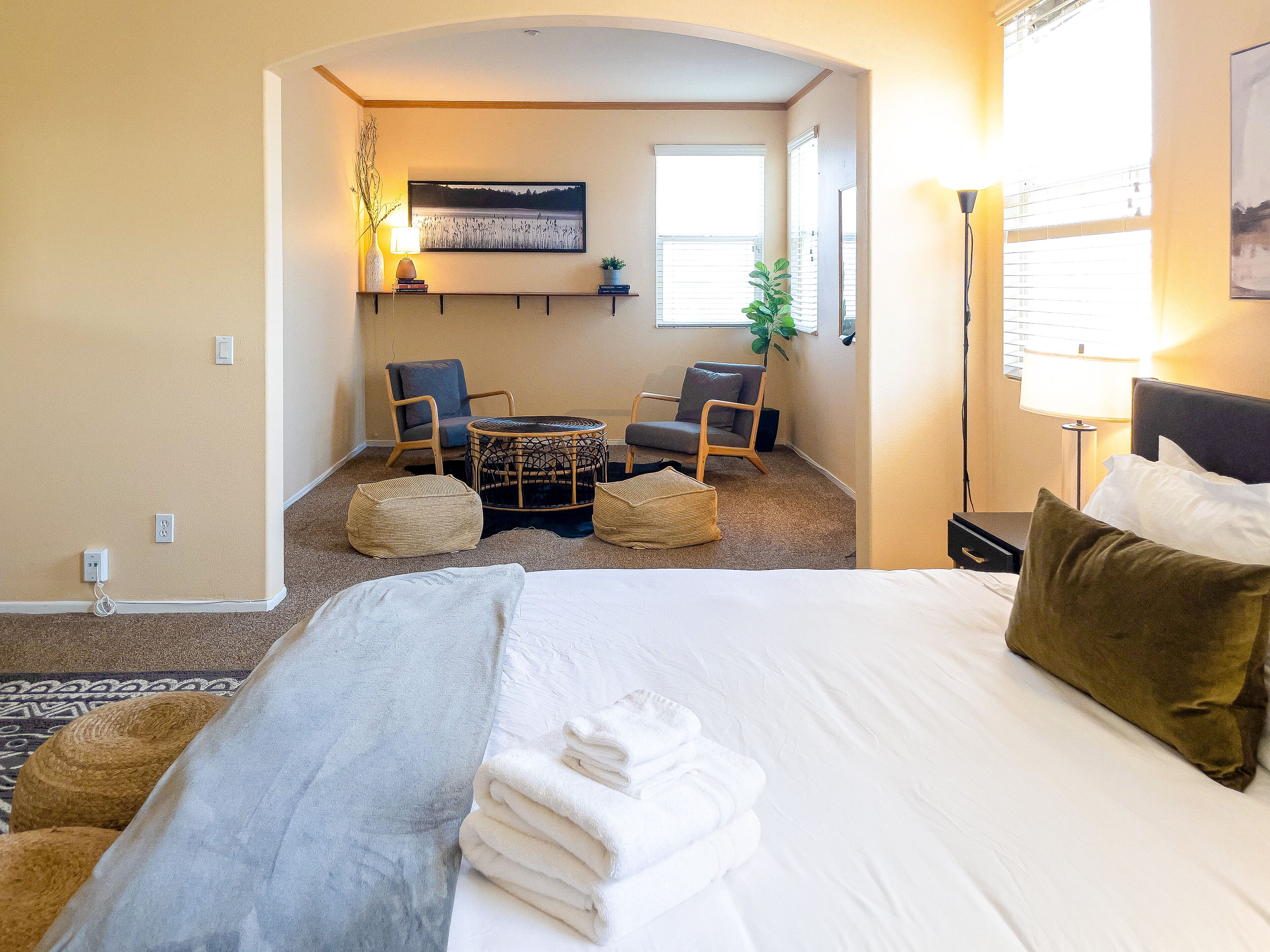 This stylish bedroom comes with a king bed & comfy chairs