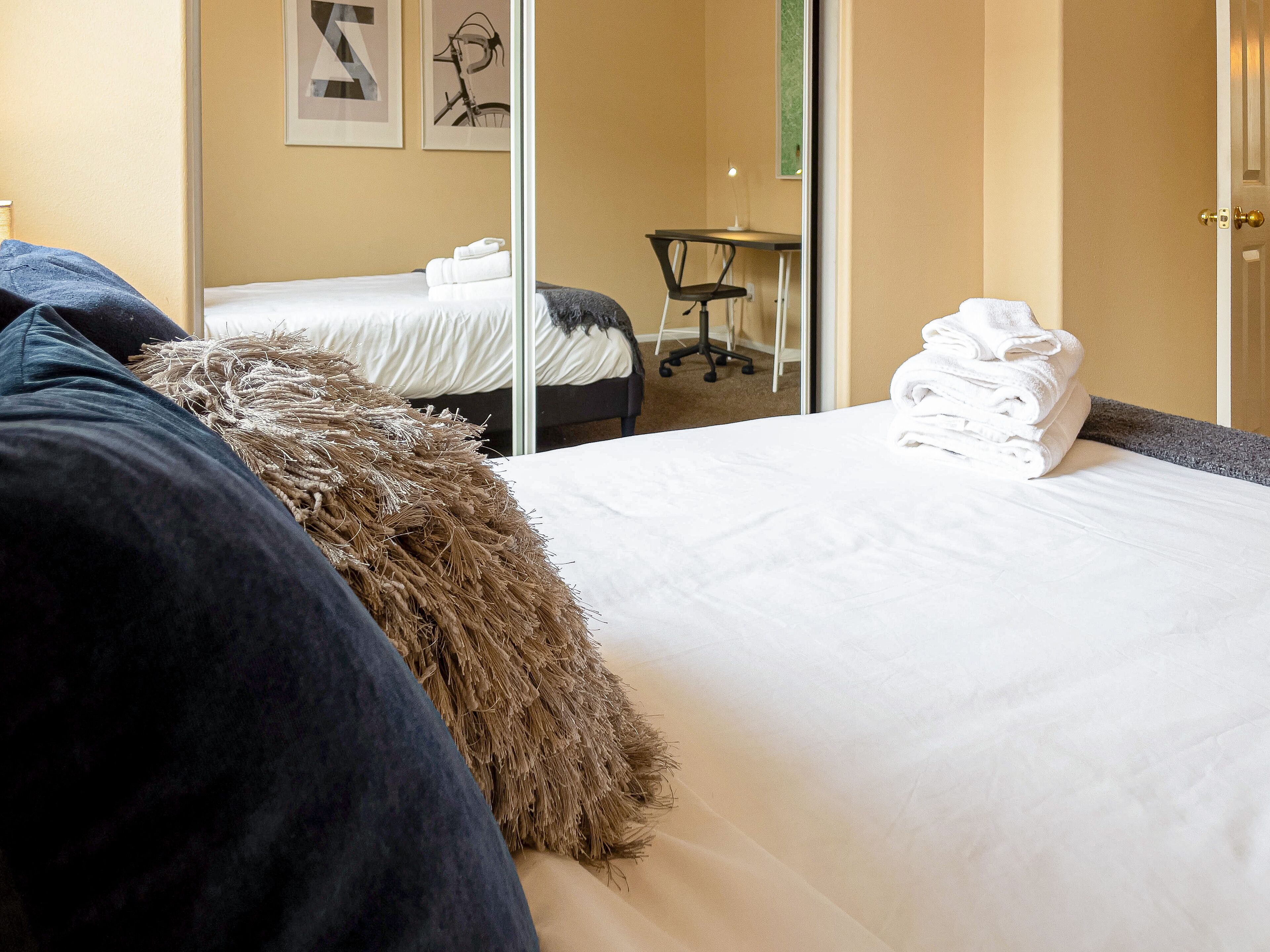 This comfy bedroom comes with a queen-sized bed and workplace area