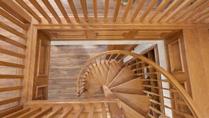 A wooden spiral staircase with a wooden ceiling and walls. - Lakefront Estate • Sleeps 23 • Firepit & Kayaks (Seguin)