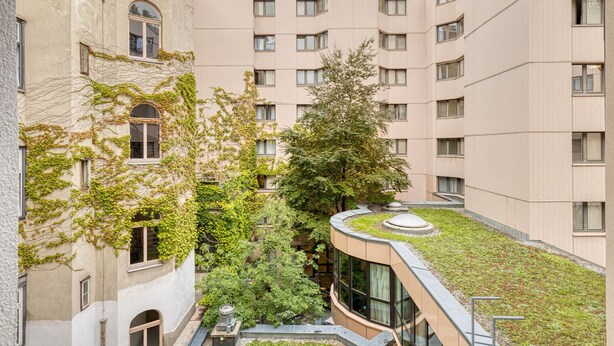 A multi-story residential building with a rooftop garden, large windows, and a mix of architectural styles. - Luxe Mariahilf 2BR w/ Elevator, near Mariahilfer Straße (Vienna)