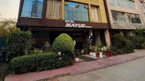 A hotel named 'Hotel Mayur Palace' with a modern facade, large windows, and a visible entrance. - Hotel Mayur Palace (Bhopal)