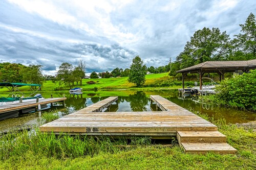 +4 acre lakefront retreat with private boat slip, wraparound porch, grill, & W/D