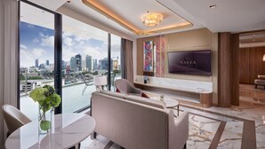 A modern hotel room with a large window offering a city view, a comfortable seating area, a flat-screen TV, and a marble floor. - Valia Bangkok Sukhumvit 24 by Kingston Hotels (Bangkok)
