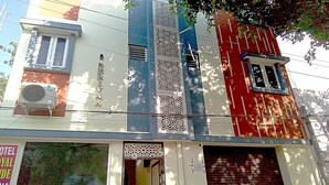 A building with a large window, a door, and a sign that reads "TOILET". - PPH Living Royal Pride (Madurai)