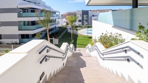 A modern building with a staircase leading to a rooftop area.