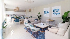 A modern living room with a sofa, coffee table, and dining area.