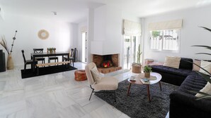 A spacious living room with a fireplace, a dining area, and a cozy seating area.