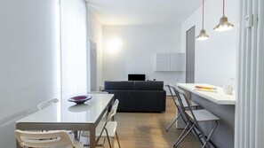 Cozy living space with a dining area, sofa, and kitchenette.