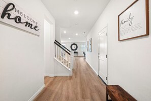 Enter a welcoming space with a sign, framed quote, and circular mirror.
