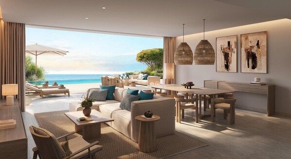 A modern living room with a large window overlooking a beach, furnished with sofas, a dining table, and hanging lights. - Ikos Odisia - All Inclusive (Corfu)