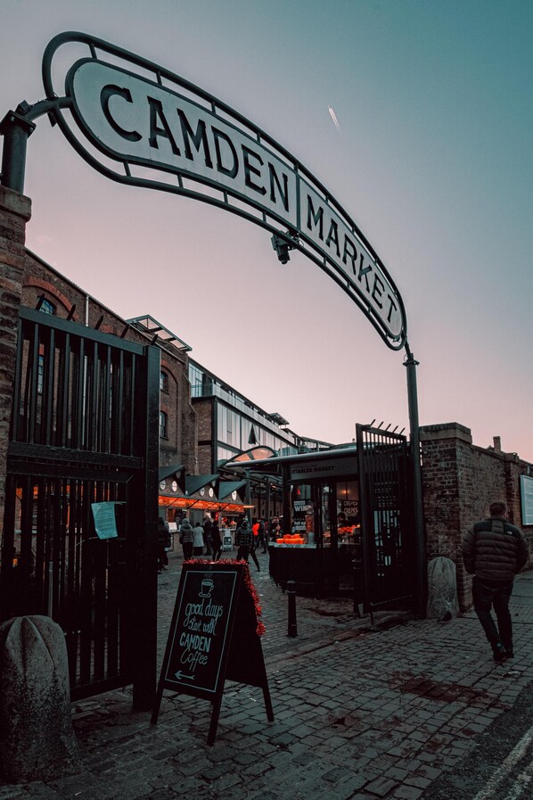 An archway labeled "Camden Market" with a sign for Camden Coffee. - The Wesley Camden Town (London)