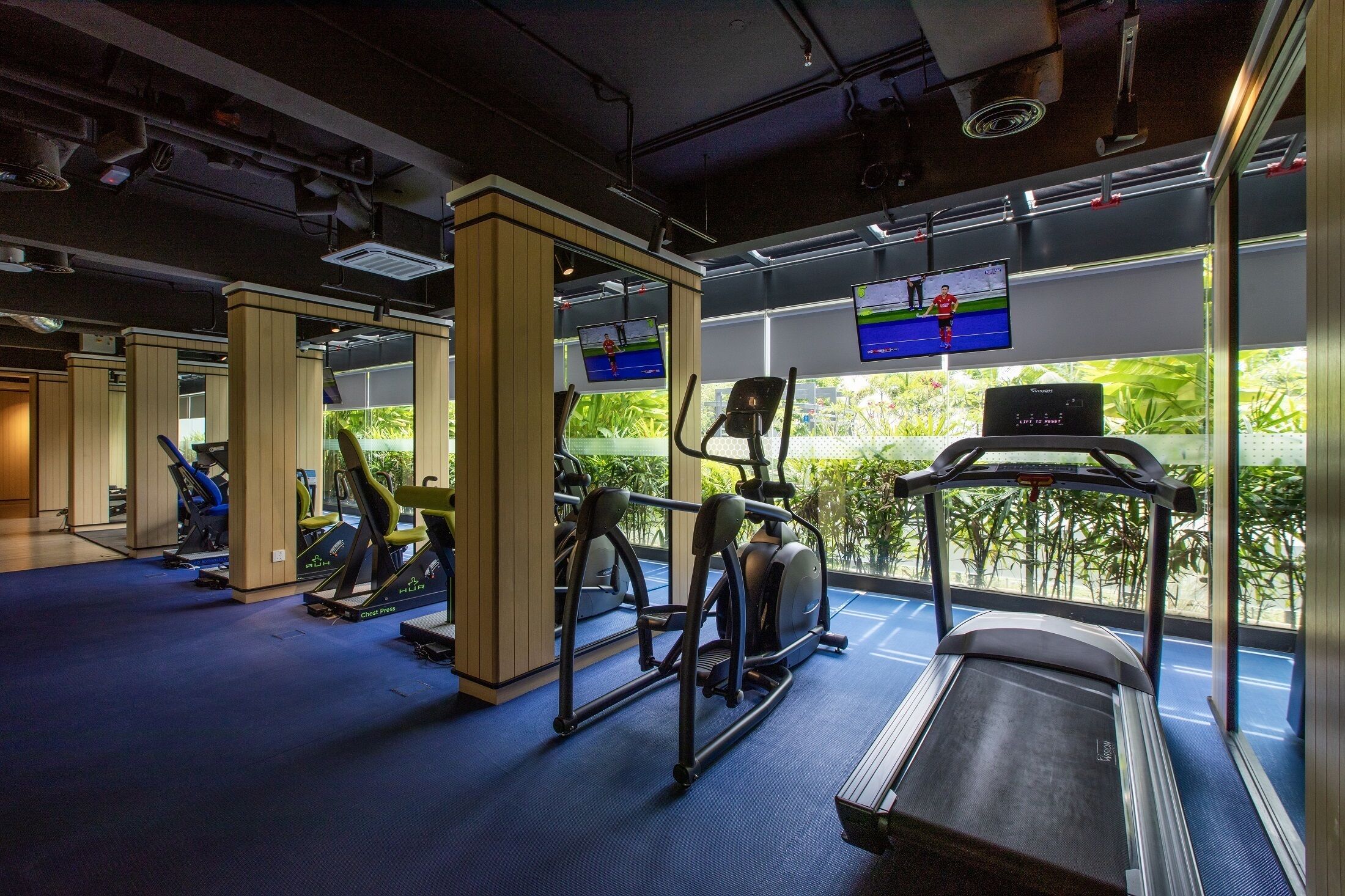 A gym with treadmills, elliptical machines, and exercise bikes.