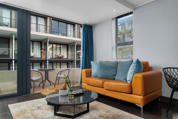 Deluxe Apartment | Living area | 48-inch flat-screen TV with cable channels, TV, Netflix - Adderley Terraces K03 (Cape Town)