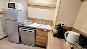 A compact kitchenette with a refrigerator, microwave, dishwasher, sink, and coffee maker. - Renovated apartment, ski-in/ski-out, balconies, 3 rooms for 8 ppl. (Les Arcs 2000)