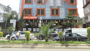 A multi-story building with a sign for 'ABAT GUEST HOUSE' and 'HANOLY NOOSE'. - Abat Guest House (Addis Ababa)
